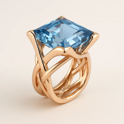 The Ava – Gold Statement Ring with Sky Blue Faceted Gemstone