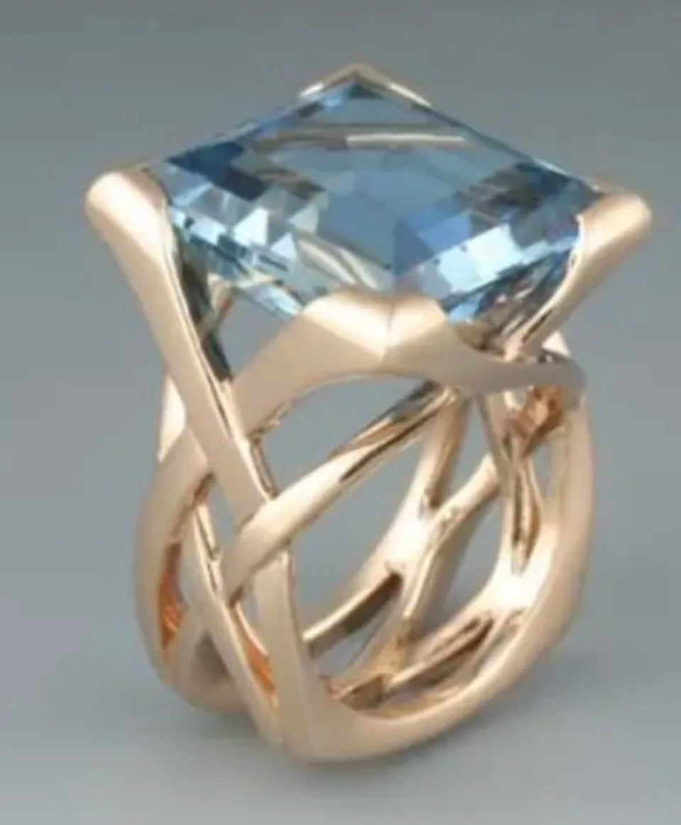 The Ava – Gold Statement Ring with Sky Blue Faceted Gemstone